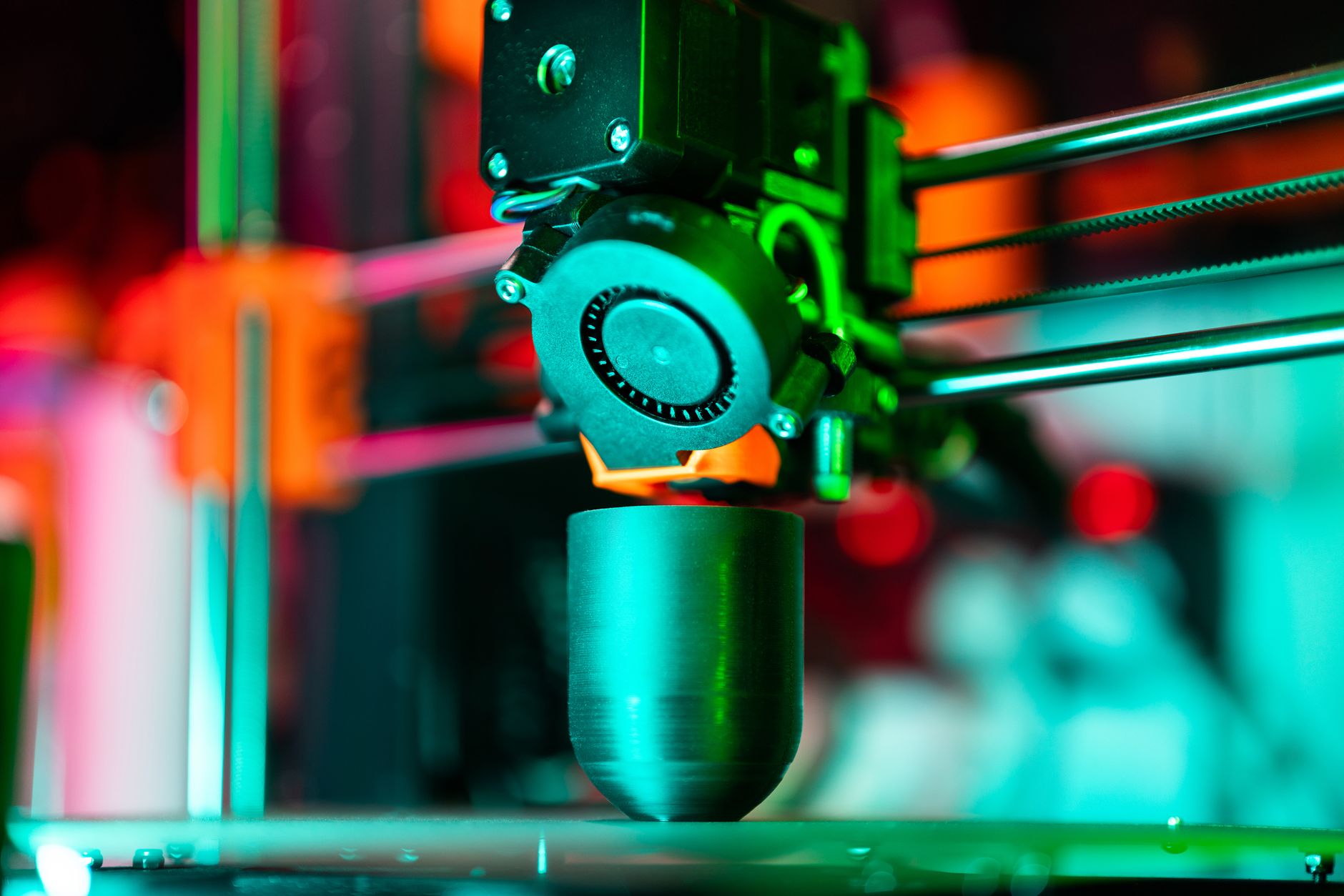 Close up of a brass brush cleaning a 3D printer nozzle