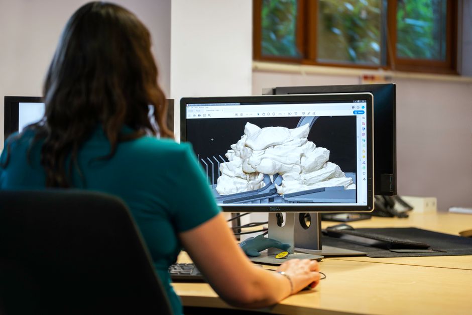 Child designing simple 3D printable model on laptop